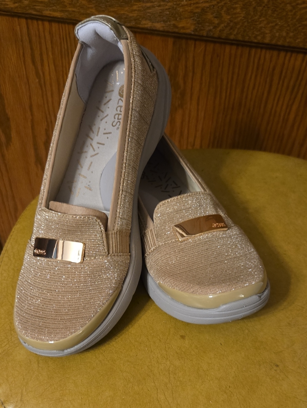 Bzees Women's Shimmer Slip-On Loafer in Beige with Gold Accent